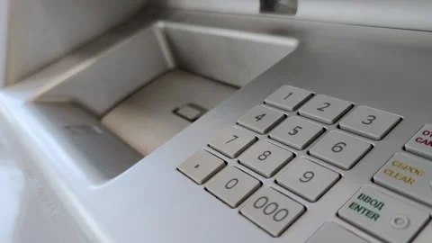 Female hand entering pin code on ATM keypad and putting money in money slot Stock Footage 284331064