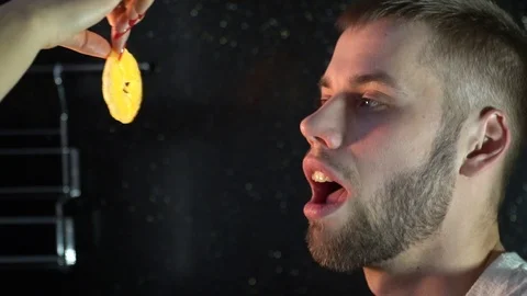 A female hand feeds a man with a slice of sour lemon Stock Footage 86152092
