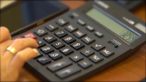 The female hand is gaining a number, doing calculations on the calculator Stock Footage 105287313