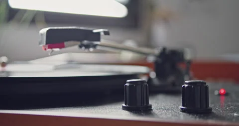Female hand going down headshell of vintage portable record player and start Stock-Footage 131302169