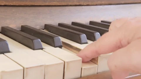 Female hand gracefully playing worn keys antique piano, act creating music .. Stockbeeldmateriaal 346785386