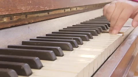 Female hand gracefully playing worn keys antique piano, act creating music .. Stockbeeldmateriaal 346785420