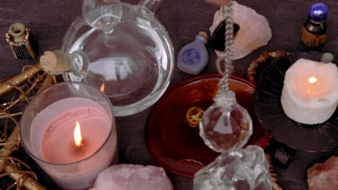 Female hand holding and using glass ball crystal ball, pendulum swings over.. Stock Footage 245814819