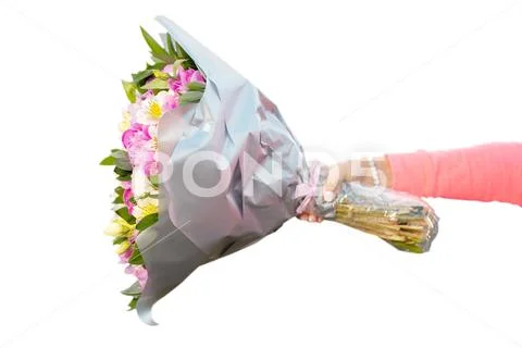 Female hand holding bouquet of flowers horizontally Stock Photos