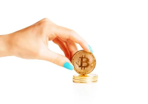 Female hand holding stack of gold bitcoins. Stock Photos