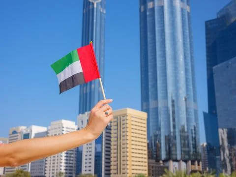Female hand holding tiny flag of UAE Stock Photos