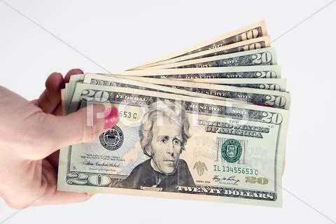 Female hand holds cash payment currency twenty dollar money green backs Stock-Fotos