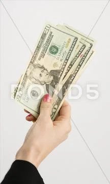 Female hand holds cash payment currency twenty dollar money green backs Stock-Fotos