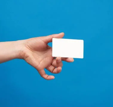 Female hand holds a rectangular white paper blank business card Foto stock