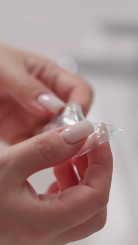 Female hand holds transparent patch for skin around eyes Stock Footage 309808381
