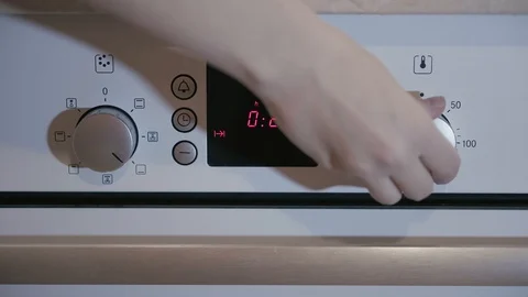 Female hand includes Metallic Toggle Switch of the Cooker Oven Stock Footage 103206862