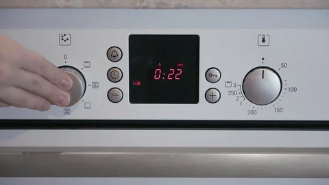 Female hand includes Metallic Toggle Switch of the Cooker Oven Stock Footage 103206981