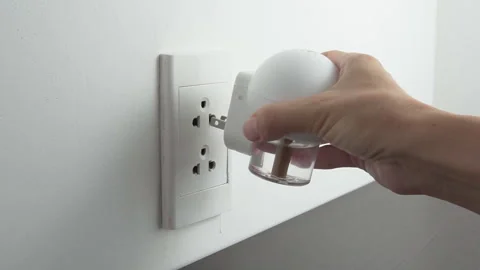 Female hand inserting electric device with mosquito repellent Stock Footage 278403162