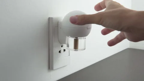 Female hand inserting electric device with mosquito repellent Stock Footage 279531260