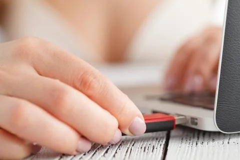 Female hand inserting flash drive. Stock Photos