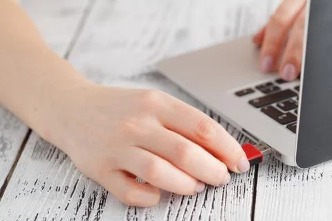 Female hand inserting flash drive. Stock-Fotos