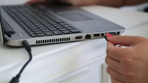 Female hand inserting USB cable into laptop 2 Video stock 79054642