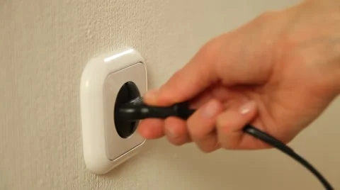 Female hand inserts a plug into a socket and removes it - closeup shot Stock Footage 61268978