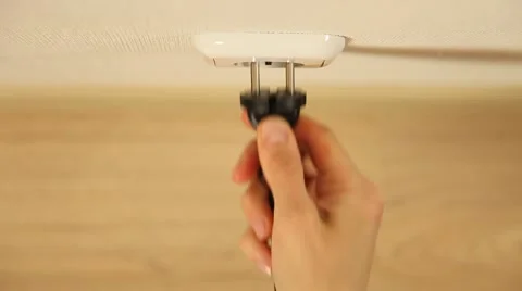 Female hand inserts a plug into a socket and removes it Stock Footage 61269180