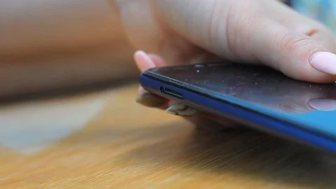 Female hand inserts a sim card into the phone Stock Footage 113550556