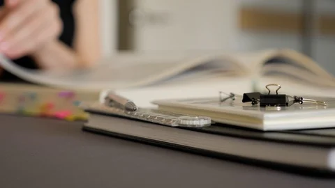 Female hand leafing through the pages of a big book. Stock Footage 129501088
