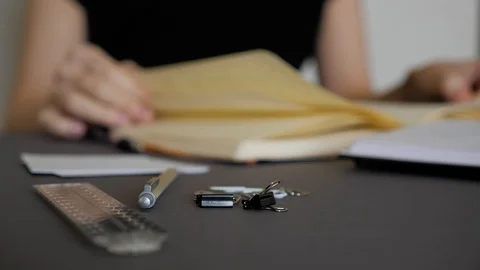 Female hand leafing through the pages of a book. Stock Footage 129812652