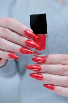 Female hand with long nails and a bright red manicure Stock Photos