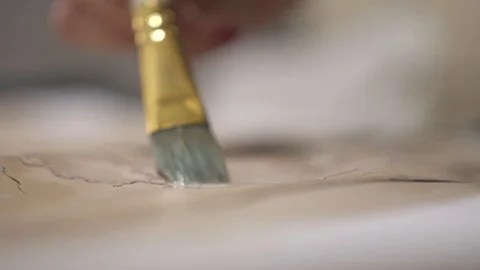 Female hand make aged map with paint brush and transparent watercolor, close-up Stock-Footage 94766670