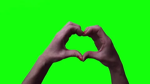 Female hand making heart shape gesture isolated on green screen chroma key Stock Footage 141910177