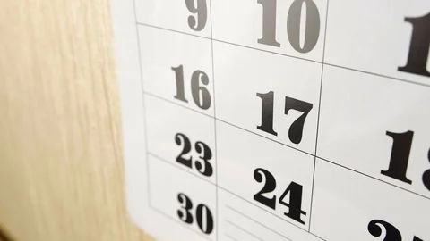 Female hand note birth day with red marker the calendar day 17. Slow motion shot Stock Footage 121077115