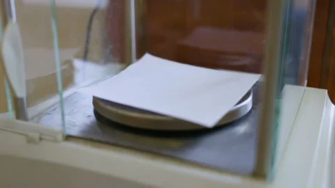 The female hand opens and closes the door of analytical high-precision scales. I Stock Footage 85612985