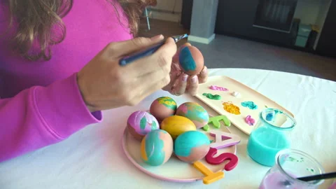 Female hand painted Easter eggs, paints and brushes. Preparation for the holiday Stock-Footage 151354582