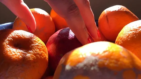 Female hand picking up fruit in slow motion Stock Footage 124941783