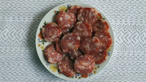 Female hand picking a slice of salami from a plate Stock-Footage 116985596