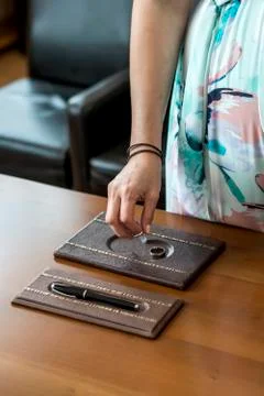 Female hand picking up wedding ring from table for groom during ceremony Stock Photos