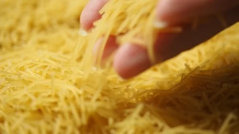 Female hand picks dry thin short noodles for cooking Stock Footage 110791187