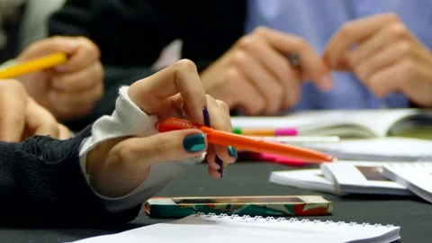Female hand is playing with a pen at the table for a meeting Stock Footage 140224078