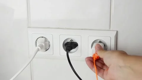 Female hand plugging an electrical power plug into a wall socket. 스톡 동영상 339006822