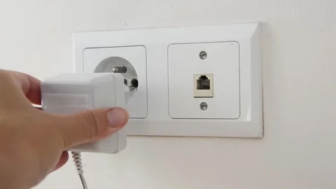 Female hand plugging an electrical power plug into a wall socket. 스톡 동영상 339006828