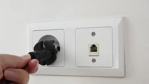 Female hand plugging an electrical power plug into a wall socket. 스톡 동영상 339006855