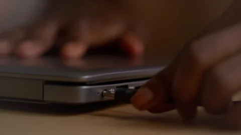 Female Hand Plugging Power Cable into Socket on Laptop Computer Stock Footage 317977221