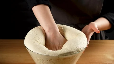 Female hand pops the risen bread dough in slow motion 4K - 120fps Stock Footage 266220179