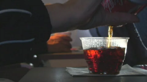Female hand pours fizzing soft drink aboard flight Stock Footage