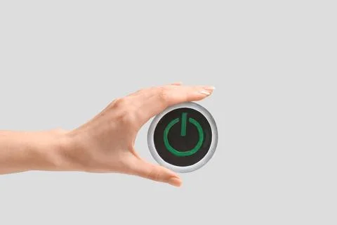 Female hand with power button on light background. Start concept Stock Photos