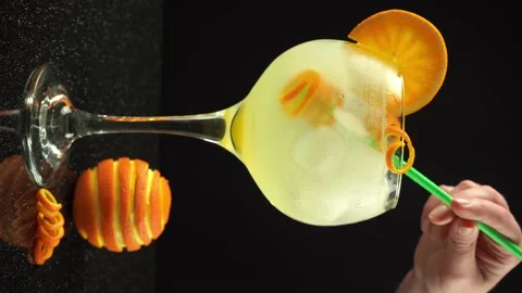 Female hand preparing gin orange cocktail with ice, 4k vertical video, close up Stock Footage 171290765