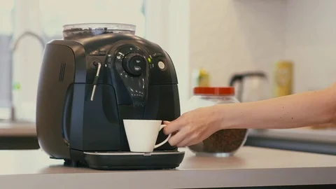 Female hand presses button of the coffee machine and begins preparation of drink Stock Footage 71629201