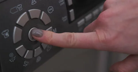 Female hand presses button on control panel on washing machine Video stock 230093698