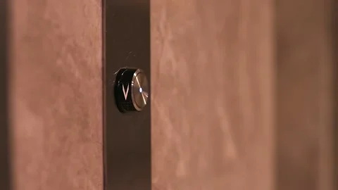 Female hand presses the elevator call button. Index finger of hand presses Stockbeeldmateriaal 218610338