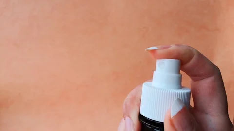 Female hand presses the spray button Stock Footage 103857772