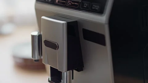 Female Hand Pressing Button on Coffee Machine to Brew Espresso Stock Footage 317973162